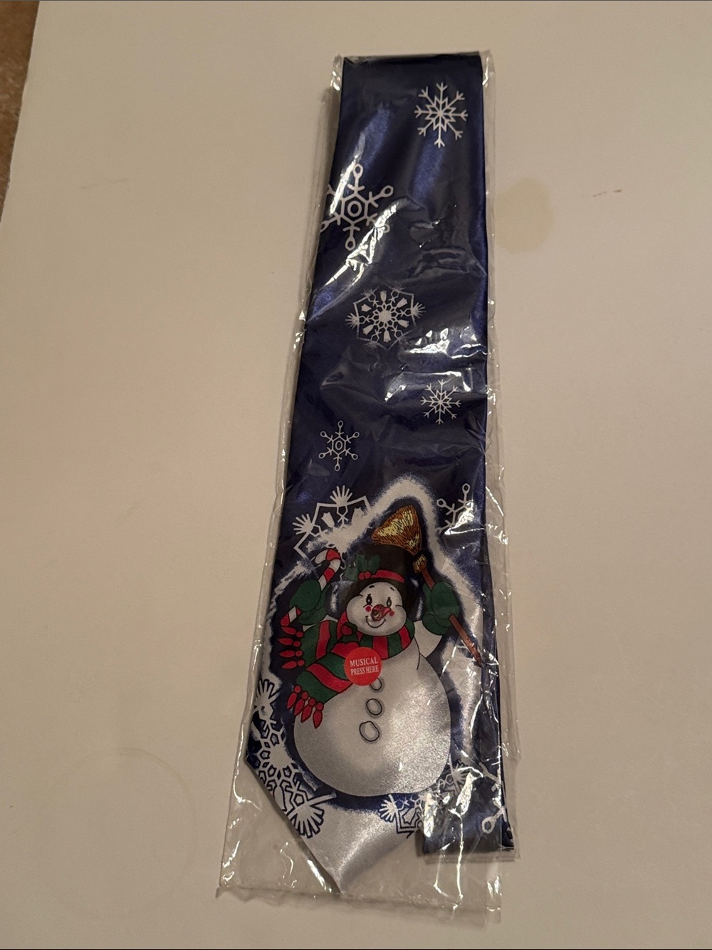 Blue Snowman Holiday Tie Push button and it lights up and plays a tune.